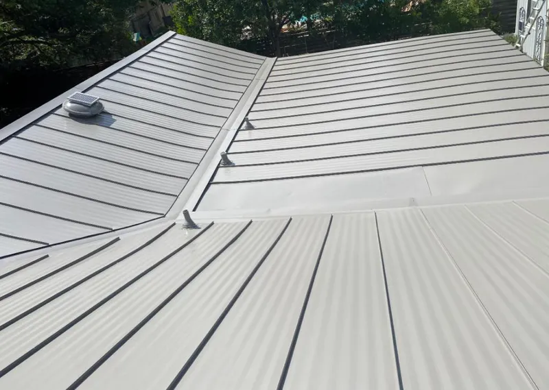 Solar attic fan installed on a metal roof for Roof Ventilation in Surf City